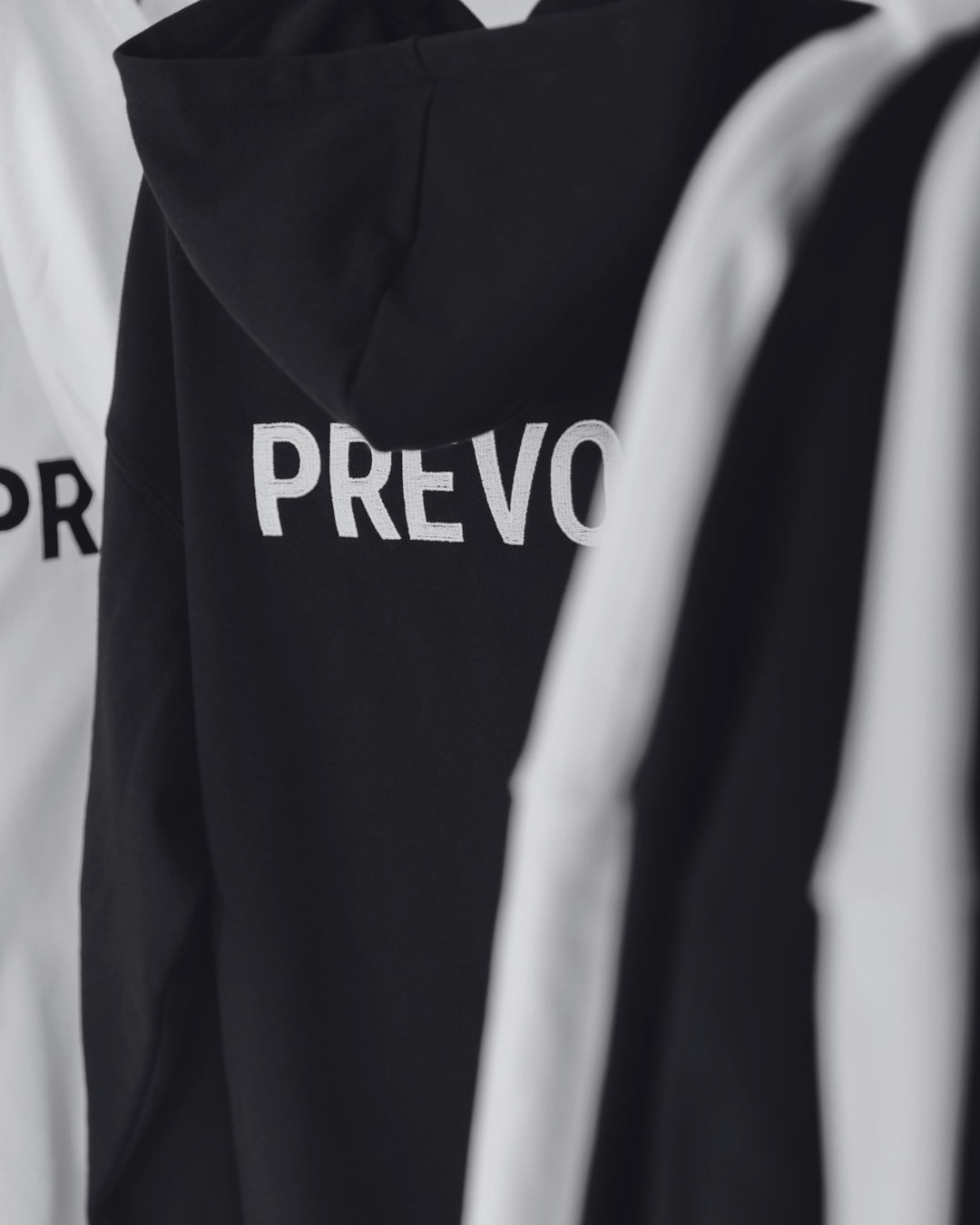 Prévost OG hoodies in black and white with logo on back
